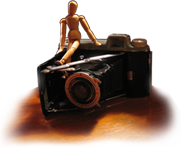 Antique camera and artist manikin.